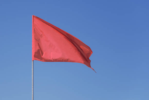 istock Red flag against the blue sky 1085861924