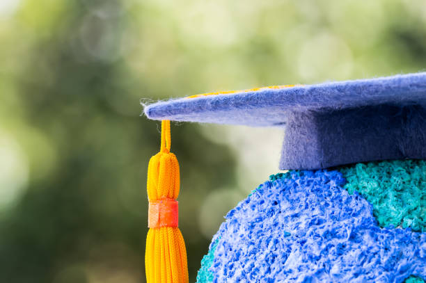 istock Education world or Graduated study abroad international ideas. Graduation hat on top Paper Mache Craft Earth globe. Concept of Congratulations to graduates university lead to success in world amd life 1085872964