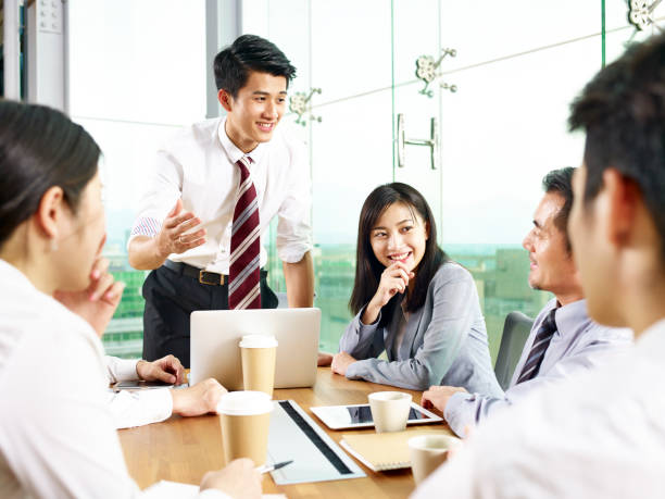 asian business man presenting ideas to group