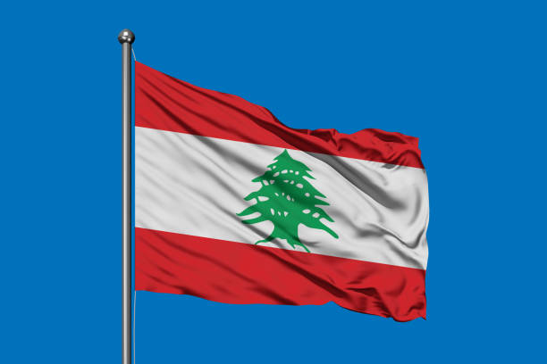 flag of lebanon waving in the wind against deep blue sky. lebanese flag. - lebanese flag imagens e fotografias de stock