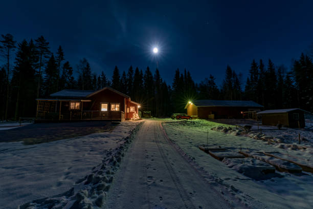 istock red little cabin in moon light and snow 1085877262