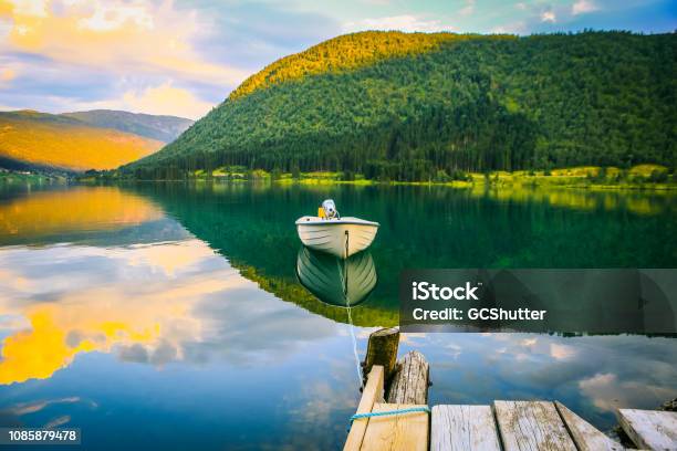 Empty Boat Tied To The Dock With A Rope On The Calm Fjord Stock Photo - Download Image Now