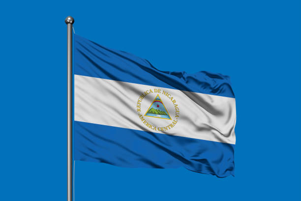 Flag of Nicaragua waving in the wind against deep blue sky. Nicaraguan flag. Flag of Nicaragua waving in the wind against deep blue sky. Nicaraguan flag. flag of nicaragua stock pictures, royalty-free photos & images