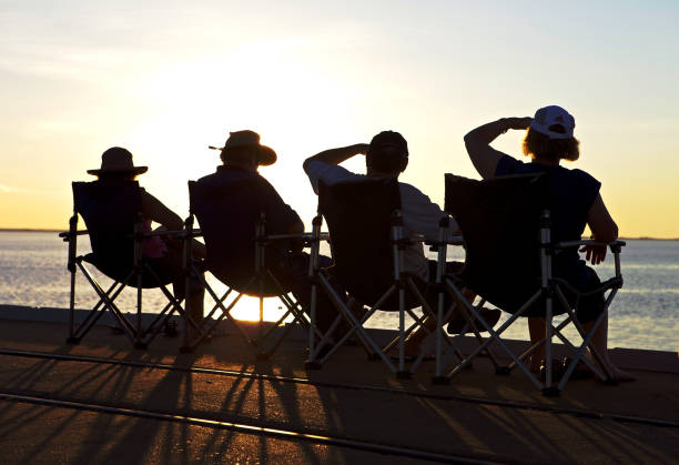 Derby, Western Australia - July 29, 2010: People sitting on the jetty in Derby .A visit to Derby wouldn't be complete without a walk along the jetty to take in the sunset