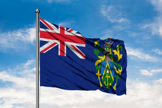 Flag of Pitcairn Islands waving in the wind against white cloudy blue sky. Flag of Pitcairn Islands waving in the wind against white cloudy blue sky. henderson waves stock pictures, royalty-free photos & images