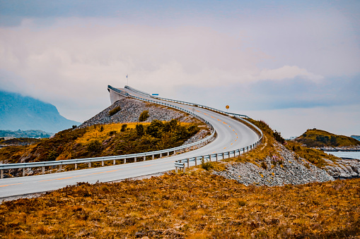 Architecture, Highway, Norway, Atlantic Road - Curving highway bridge seen from behind, seen ascending upwards into infinity.