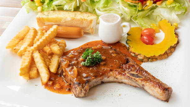 istock Pork Chop steak on a white plate. 1085905574