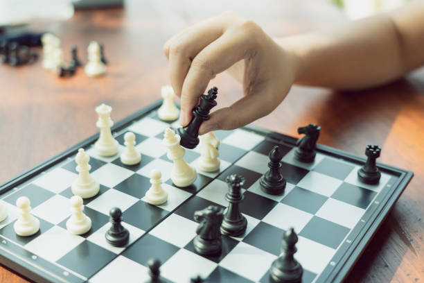 istock Businessman holding a King Chess is placed on a chessboard.using as background business concept and Strategy concept with copy space for your text or design. 1085905842