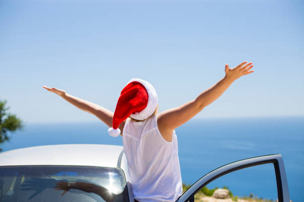 Woman on the beach in santa's hat