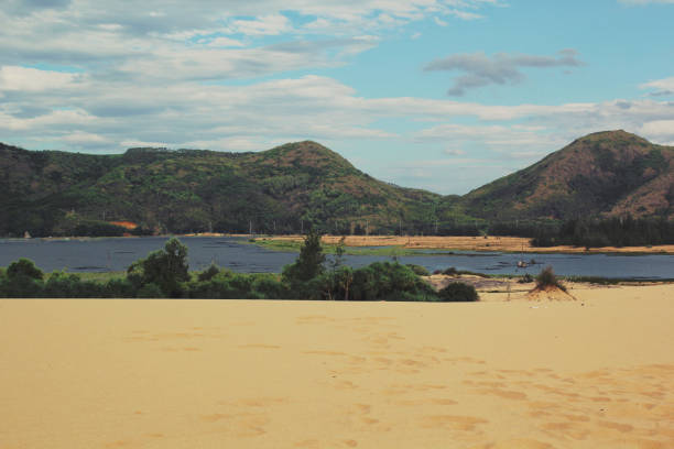 istock Nice landscape with the blue sky, mountain, lake and sand hill 1085910676