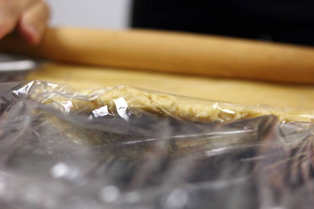 istock Rolling up dough between two layers of clear film. Making Chocolate, Pear and Pecan Pie Series. 1085913188