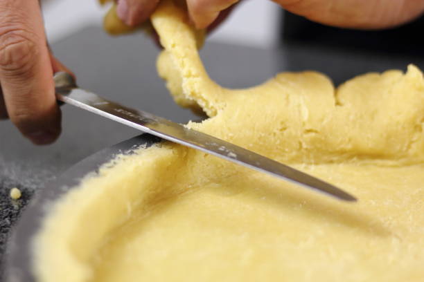 istock Trimming excess of dough. Making Chocolate, Pear and Pecan Pie Series. 1085913216