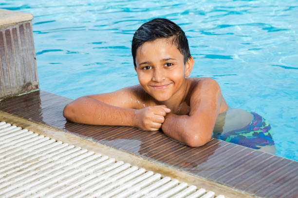 Portrait of a cute young boy in swimming pool - stock images Swimming, Swimming Pool, Exercising, Sport, Activity Swimming  stock pictures, royalty-free photos & images