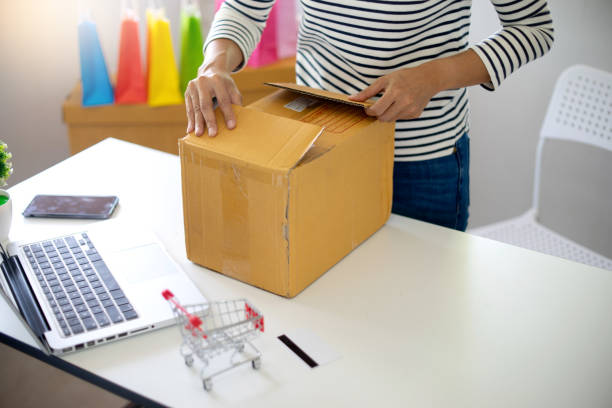 istock woman sit at computer table look at the product 1085917248