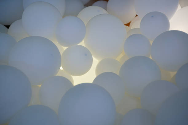 istock group of white balloons with light 1085917528