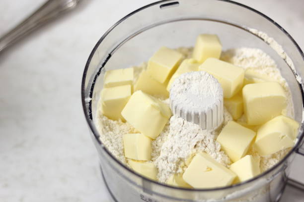 istock Add diced butter into flour. Making Lemon Mascarpone Pie Series. 1085920642
