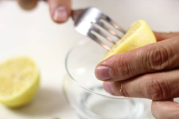 istock Juice lemon half with assistance of fork. Making Lemon Mascarpone Pie Series. 1085921038