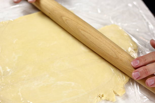 istock Roll out dough between two layers of clear film. Making Lemon Mascarpone Pie Series. 1085921218
