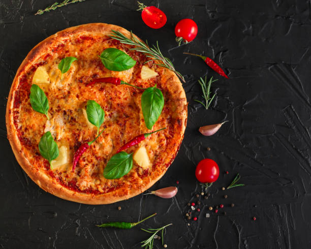 pizza, pineapples, chicken, tomato sauce, vegetables, basil (pizza ingredients). food background. copy space