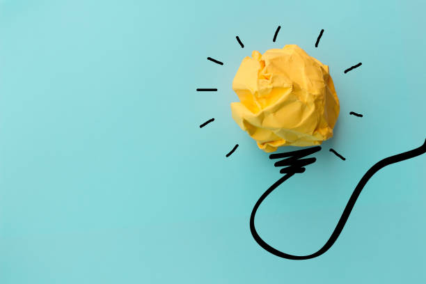istock Ideas with yellow crumpled paper ball .Creative business concept. 1085928126