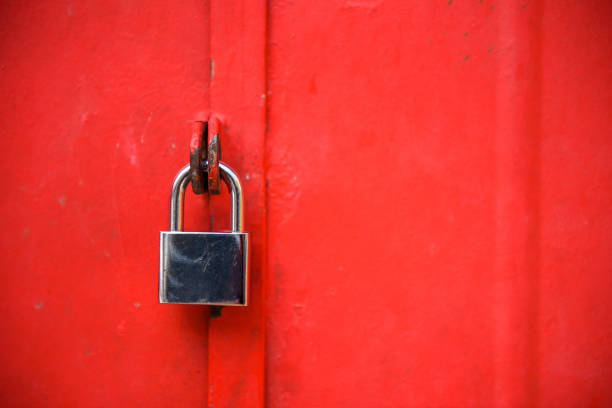 Stainless steel padlock and red door gate