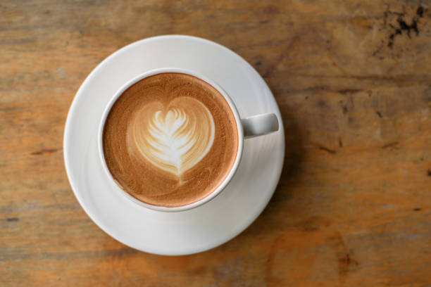 istock Coffee latte in white cup on wooden table 1085928746