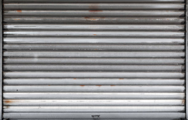 istock Closed garage door, rusted metal roll gate 1085936718