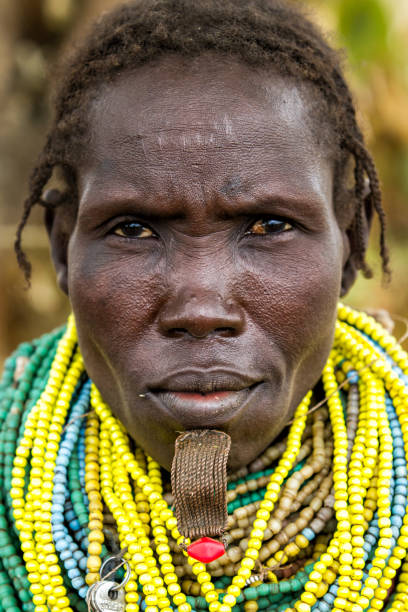 Omo Valley, Ethiopia, Nyangatom woman Omo Valley, Ethiopia, December 26, 2010: Old Nyangatom woman posing in her village. The Nyangatom are an ethnic group in the Omo Valley.The necklaces of this primitive tribe are very special. omo river photos stock pictures, royalty-free photos & images