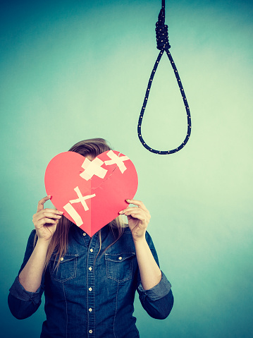 Sad depressed woman thinking about suicide after having broken heart. Relationship breakup problem, depression concept.