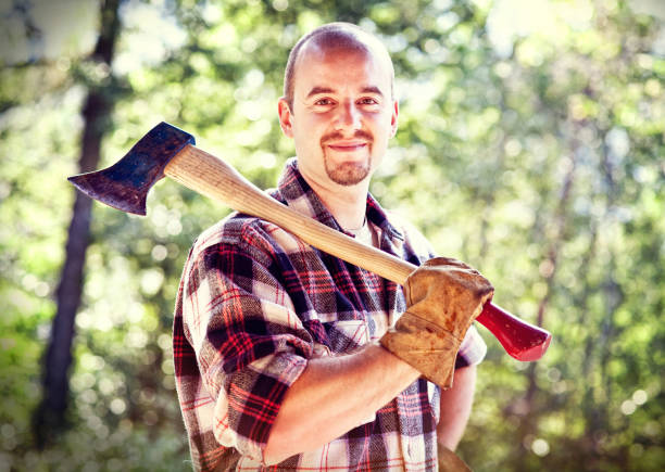istock Portrait Of Smiling Man Holding Axe While Standing Against Trees In Forest 1085947784