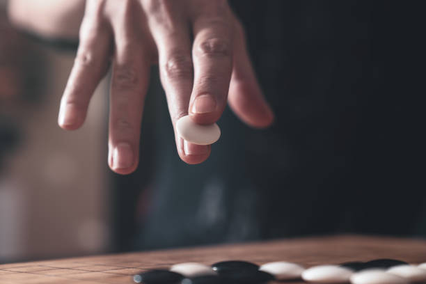 Player hand make a move in Go game.Traditional asian strategy board game
