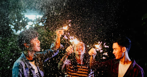 istock Friends Holding Illuminated Sparklers Outdoors At Night 1085950516