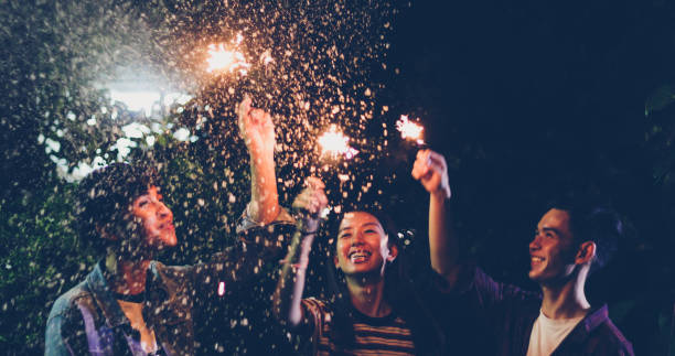 istock Friends Holding Illuminated Sparklers Outdoors At Night 1085950520