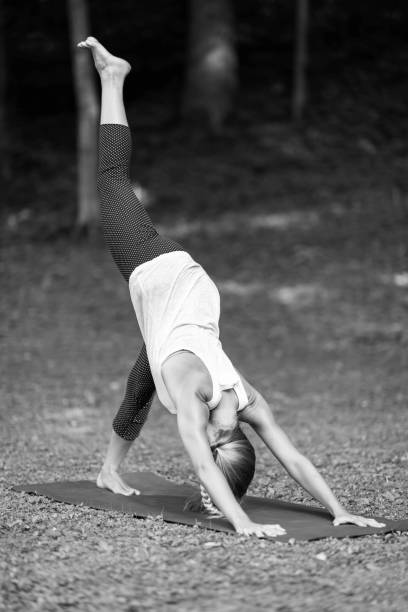 istock Young Woman Practicing Yoga At Park 1085952532