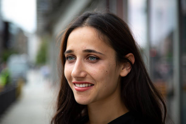 istock Smiling Young Woman Looking Away While Standing On Footpath 1085955016
