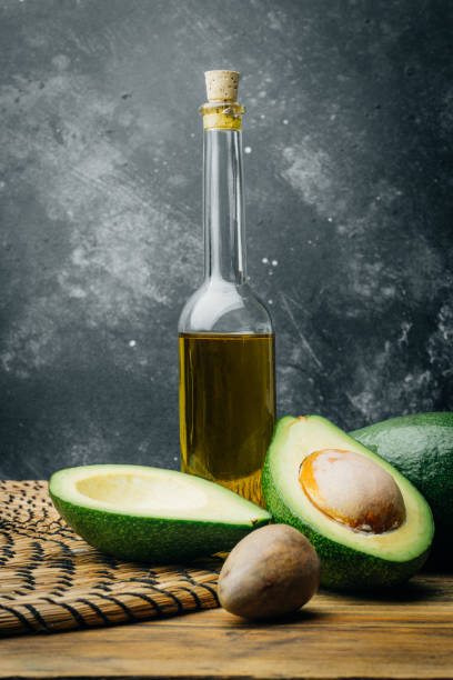 istock Avocado and avocado oil on a wooden background. Copy space. 1085957718