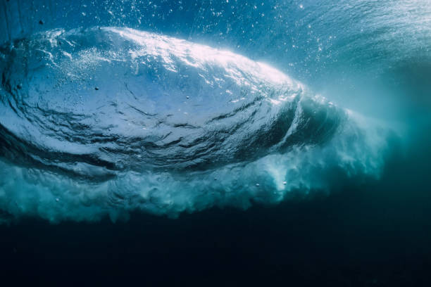 istock Blue powerful wave crashing in ocean. Underwater barrel wave and air bubbles. 1085957792