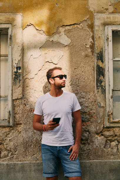 istock Modern guy using cellphone in the European city. 1085960942