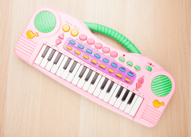 plastic pink toy piano wooden table