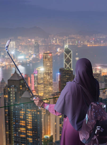 Photo of Hong Kong. Muslim woman taking selfie.