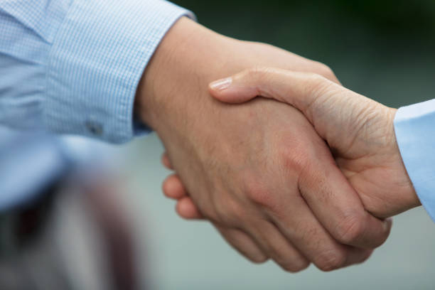 istock Close-up of people shaking hands 1085967778