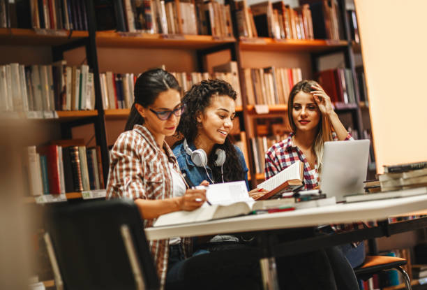istock Group of female students study in the school library.Learning and preparing for university exam.Education concept. 1085968304