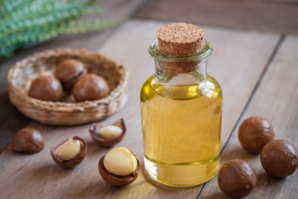 istock Macadamia oil in bottle and macadamia nuts on wooden table 1085970106