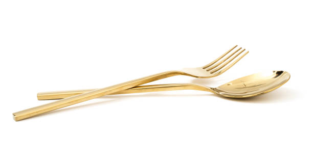 istock golden spoon and fork isolated on a white background 1085971974
