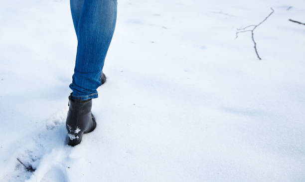 istock female feet leave footprints in the snow 1085974234