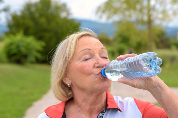 istock Sweaty grandmother drinking water 1085974410