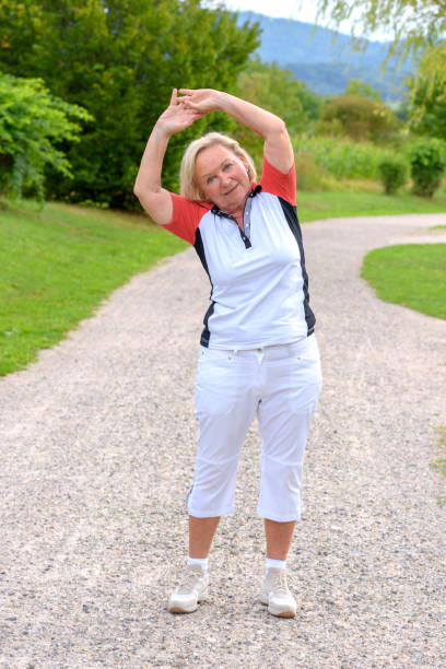 istock Sporty elderly woman doing sport exercises 1085974602