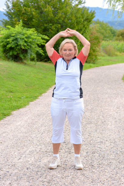 istock Sporty elderly woman doing sport exercises 1085974658