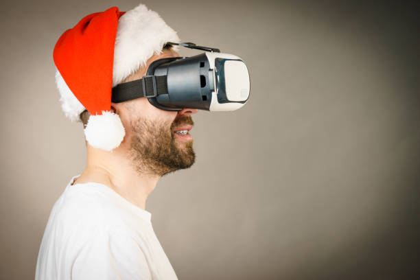 istock Man in virtual reality goggles and santa hat 1085977102
