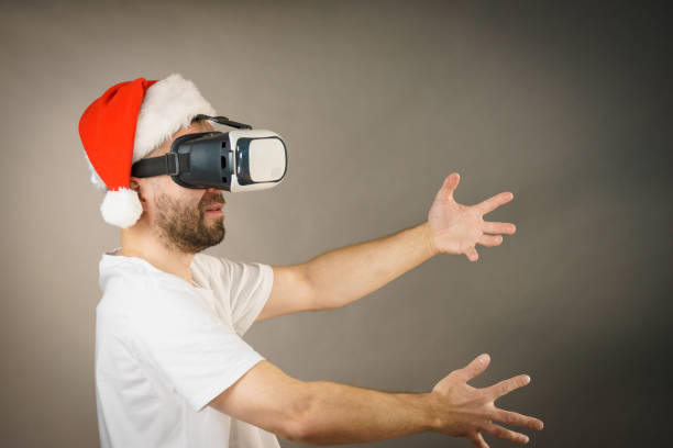istock Man in virtual reality goggles and santa hat 1085977302